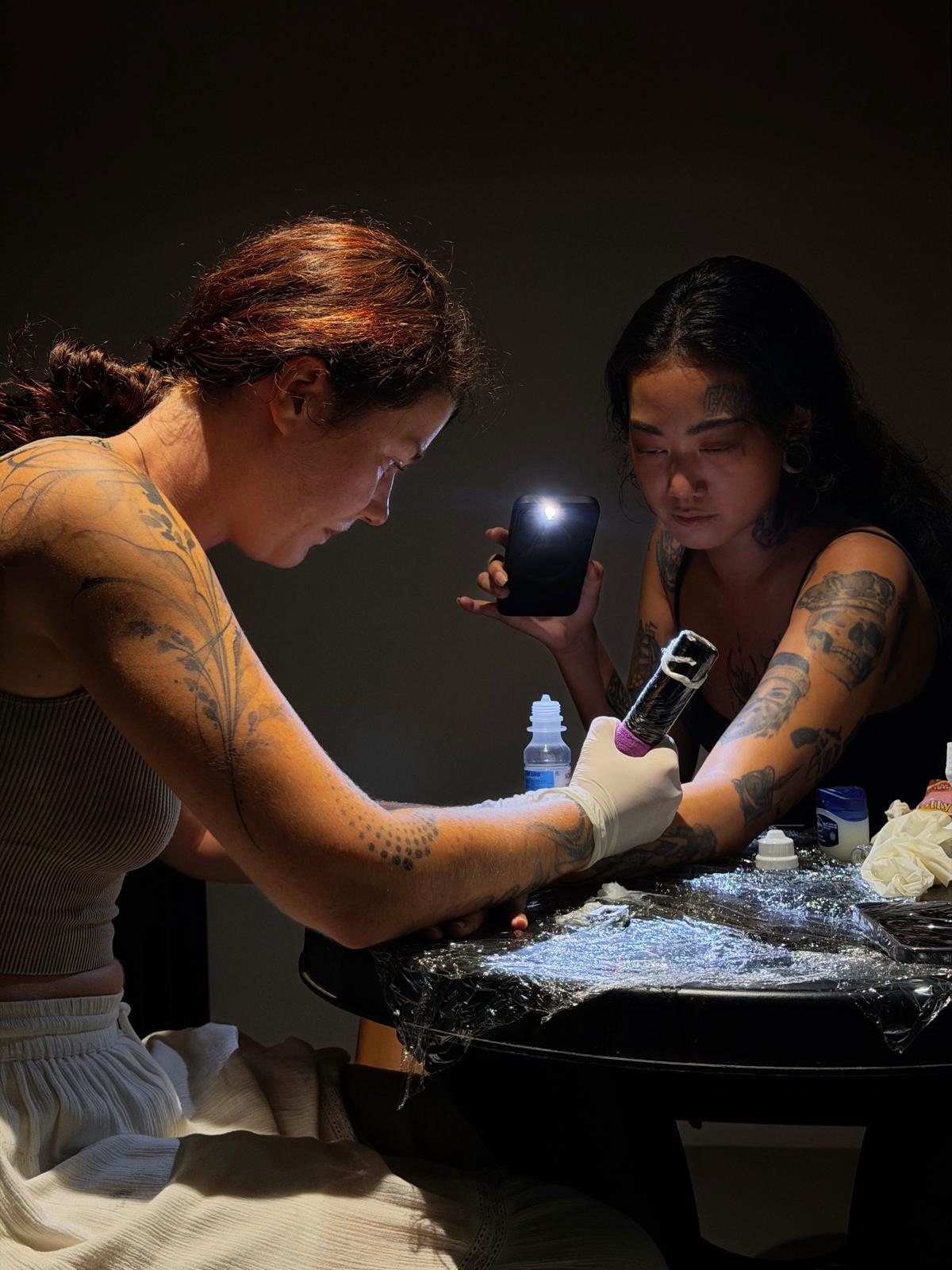 Jodi Tattoos tattooing a client at West End Art Collective in Galway