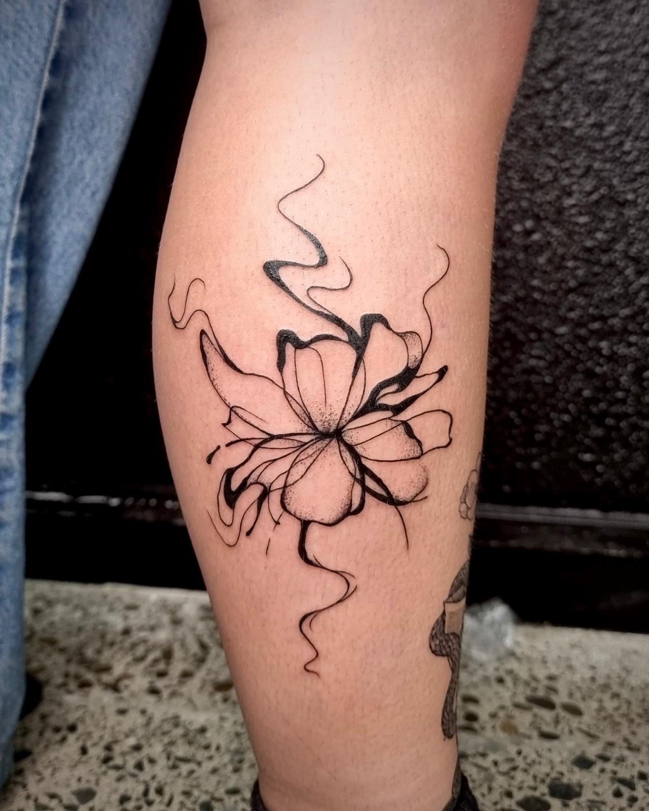 Flowing fine line and dotwork organic flower tattoo by Jodi Tattoos in Galway