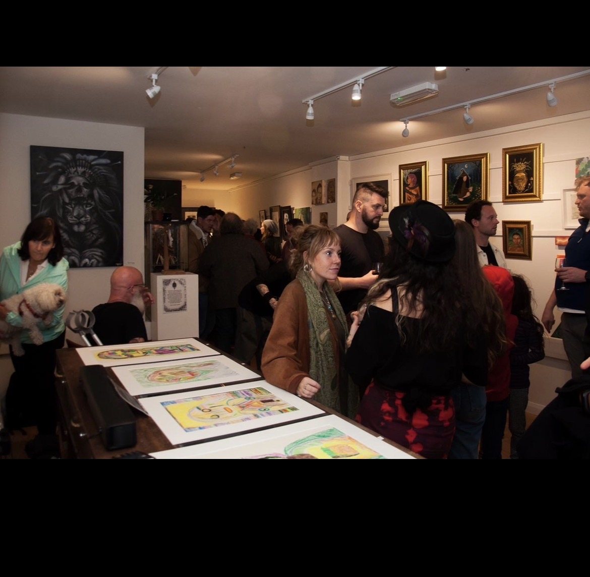 Art exhibition and visitors inside West End Art Collective gallery in Galway
